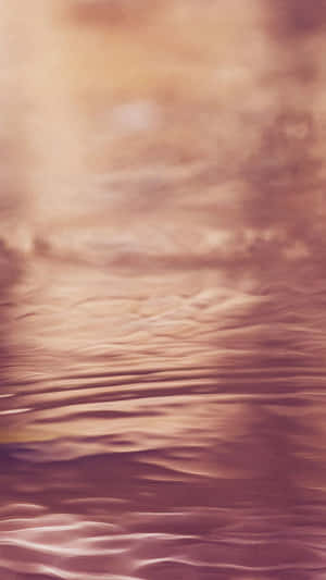 A Pink And Purple Water With Clouds Wallpaper