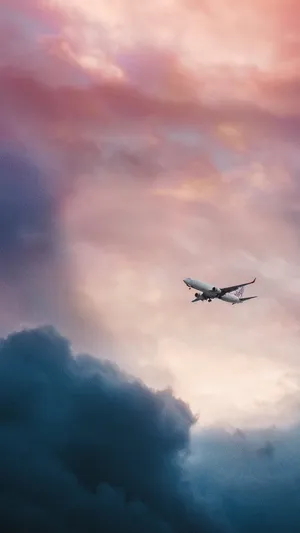 A Plane Flying Through A Cloudy Sky Wallpaper