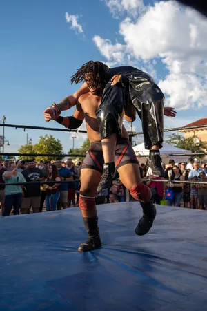 A Powerful Wrestler In Action Wallpaper