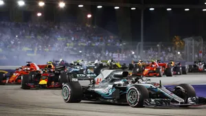 A Race Of Racing Cars On A Track Wallpaper