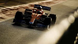 A Racing Car Driving Down A Track Wallpaper