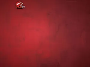 A Red Background With A Football Helmet On It Wallpaper