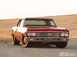 A Red Car On A Road Wallpaper