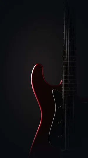 A Red Electric Guitar Is Shown Against A Black Background Wallpaper