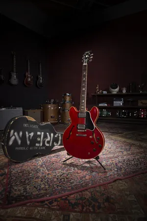 A Red Guitar Is Sitting On A Rug In A Room Wallpaper