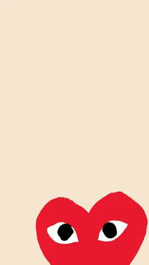 A Red Heart With Black Eyes On A Beige Background Wallpaper