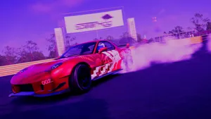 A Red Sports Car Driving Down A Track With Smoke Coming Out Of It Wallpaper