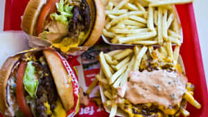 A Red Tray With Two Hamburgers And Fries Wallpaper