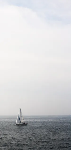 A Serene Evening Sailboat Journey Wallpaper