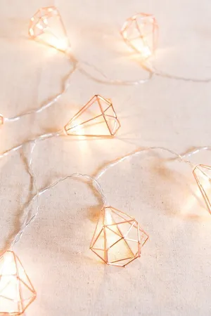 A Set Of Copper Wire Lights With Diamonds On Them Wallpaper