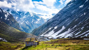 A Small Cabin In The Middle Of A Mountain Wallpaper