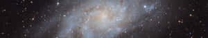 A Spiral Galaxy With Many Stars In It Wallpaper