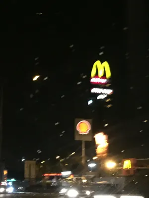 A Street With Cars Driving Down It At Night Wallpaper