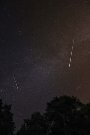 A Stunning Meteor Streaking Across The Night Sky Wallpaper