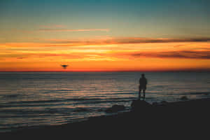 A Stunningly Peaceful View Of A Golden Sunset Wallpaper