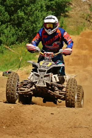 A T V Racerin Actionon Dirt Track Wallpaper
