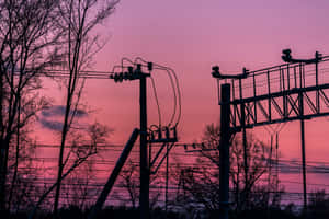 A Train Tracks With A Red Sky Wallpaper