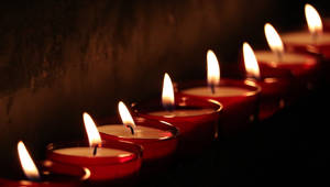 A Tranquil Row Of Candle Lights Wallpaper
