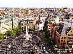 A Vibrant Gathering At Dam Square, Amsterdam Wallpaper