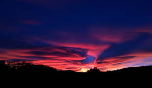 A Vivid Canvas Of Colors Adorns The Evening Sky Wallpaper