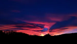 A Vivid Canvas Of Colors Adorns The Evening Sky Wallpaper