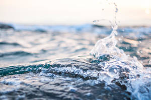 A Wave Of Refreshing Water At The Beach Wallpaper