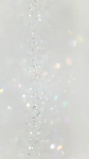 A White Background With A Lot Of Sparkles Wallpaper