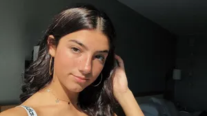 A Woman In A Black Top And Hoop Earrings Wallpaper