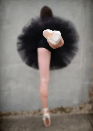 A Woman In A Black Tutu Is Posing Wallpaper