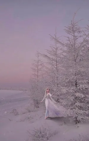 A Woman In A White Dress Is Standing In The Snow Wallpaper