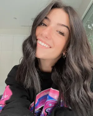 A Woman With Long Hair And A Black Sweatshirt Smiling Wallpaper