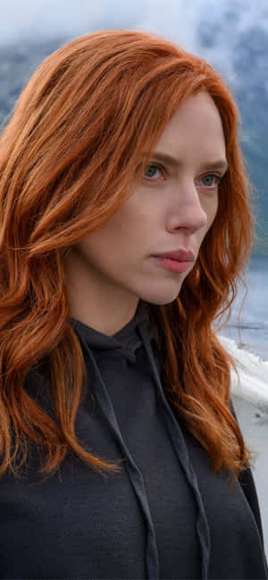 A Woman With Red Hair Standing On A Boat Wallpaper