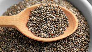 A Wooden Scoop Of Nutrient-dense Chia Seeds Wallpaper