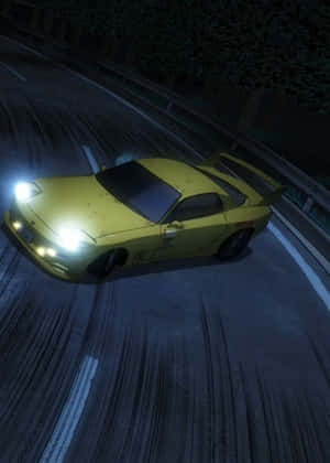 A Yellow Car Driving Down A Road At Night Wallpaper