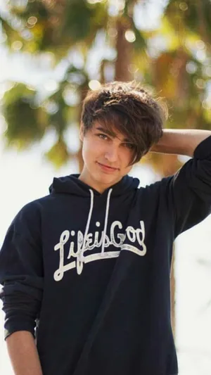 A Young Man Wearing A Black Hoodie With The Word Lifegod On It Wallpaper