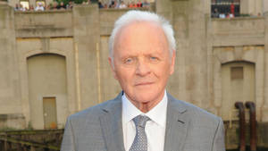 Acclaimed Actor Anthony Hopkins In A Grey Sweater Wallpaper