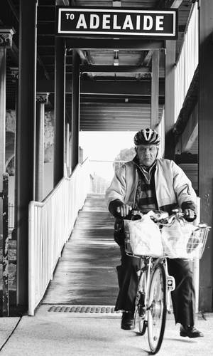 Adelaide Signage Above Elderly On Bicycle Wallpaper