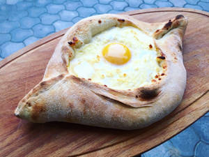 Adjarian Khachapuri Cheese Bread Laid On Wooden Pan Wallpaper