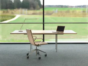 Adjustable Office Desk Set Against A Transparent Glass Wall Wallpaper