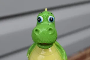 Adorable Toy Dinosaur In Close-up Shot Wallpaper