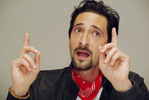 Adrien Brody Pointing Upward Enthusiastically Wallpaper