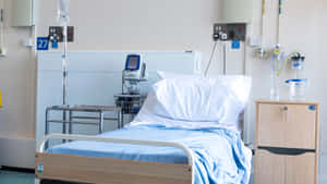 Advanced Hospital Bed Equipped With Medical Apparatus Wallpaper