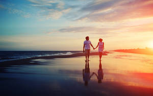 Aesthetic Couple In Wet Beach Sand Wallpaper