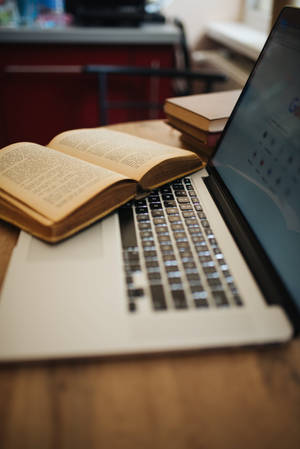 Aesthetically Pleasing Desk Setup With Books Wallpaper