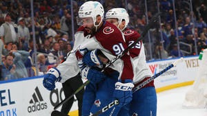 Aggressive Passion - Nazem Kadri Held Back By Teammate During A Heated Game Moment. Wallpaper