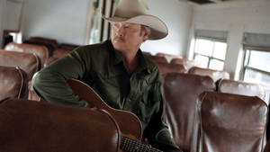 Alan Jackson With Guitar On Bus Wallpaper