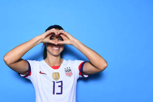 Alex Morgan Heart Pose Wallpaper