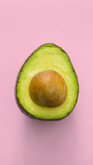 An Avocado On A Pink Background Wallpaper