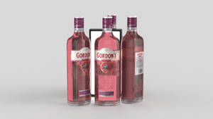 An Enthralling View Of Four Gordon's Premium Pink Gin Bottles Aligned In A Row. Wallpaper