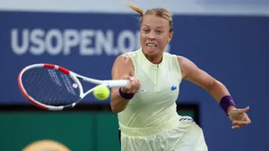 Anett Kontaveit In Yellow Striking Ball Wallpaper